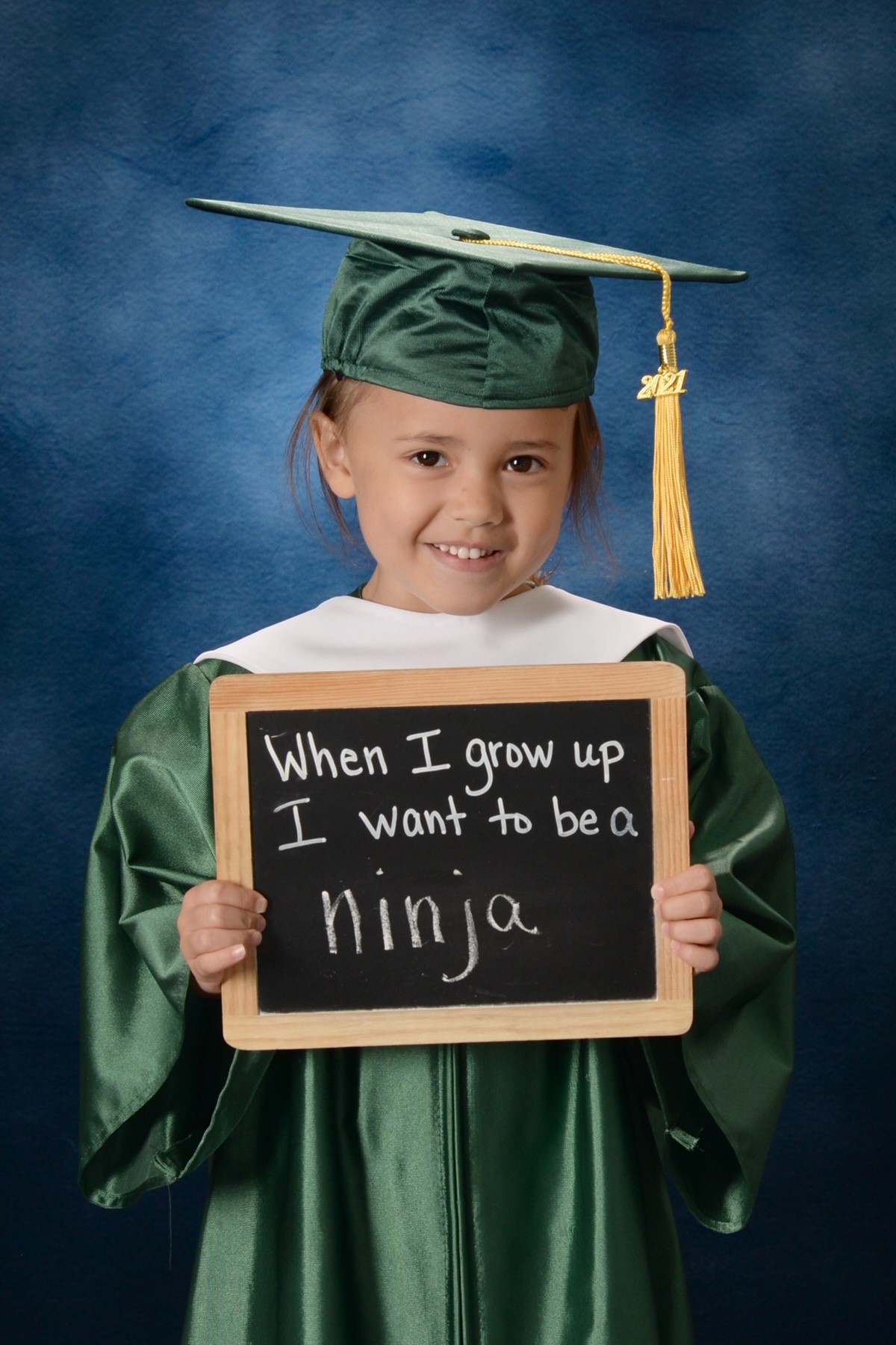 A young girl posing for a graduation photo