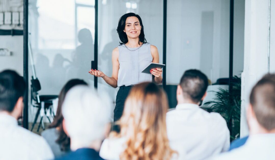 Professional female financial advisor leads a seminar for prospects.