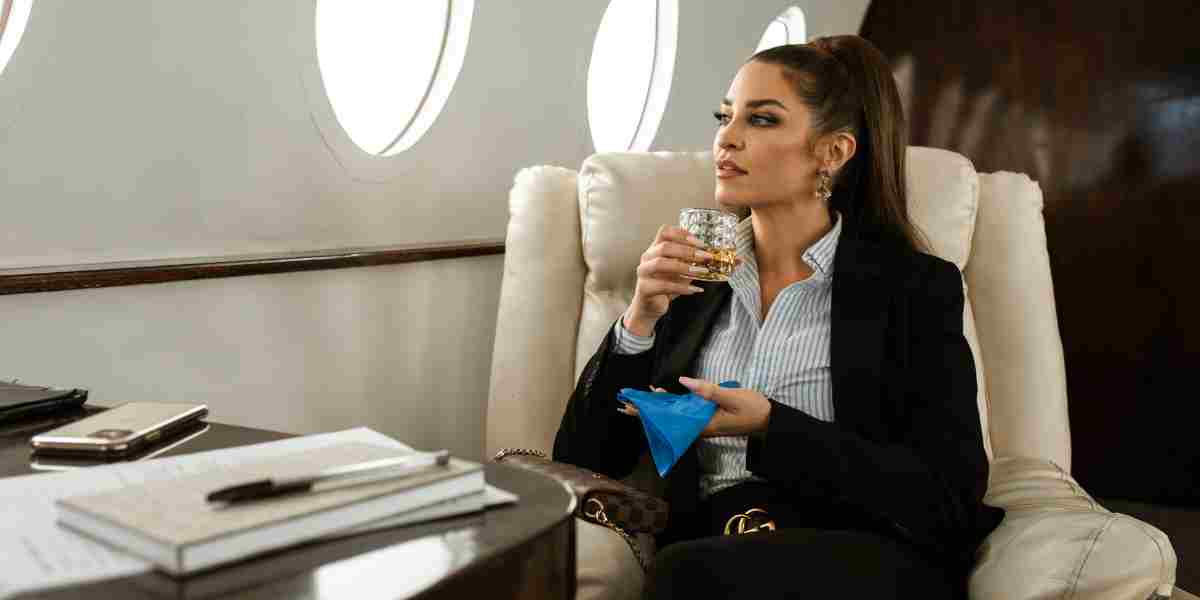 Successful business woman sits on a private plane drinking a beverage.