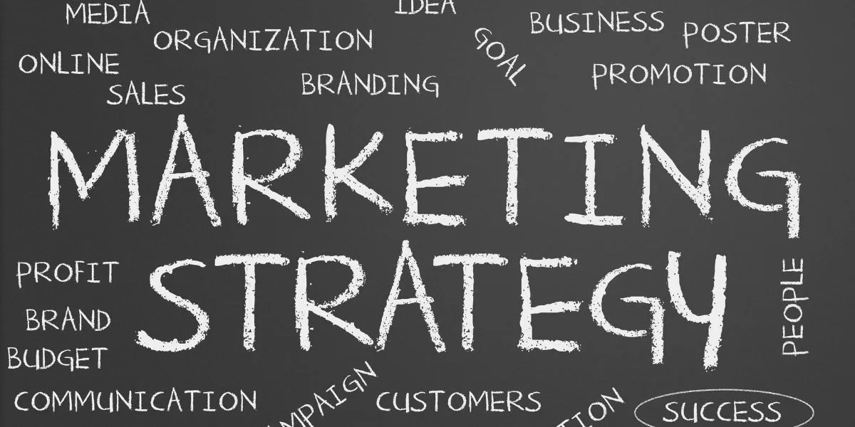 Black chalkboard with Marketing Strategies and other marketing related words in white chalk