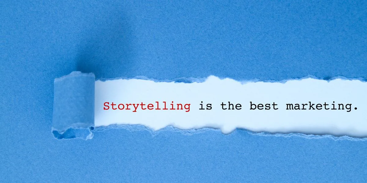 Blue paper with a segment torn. Underneath the tear, is says "Storytelling is the best marketing"