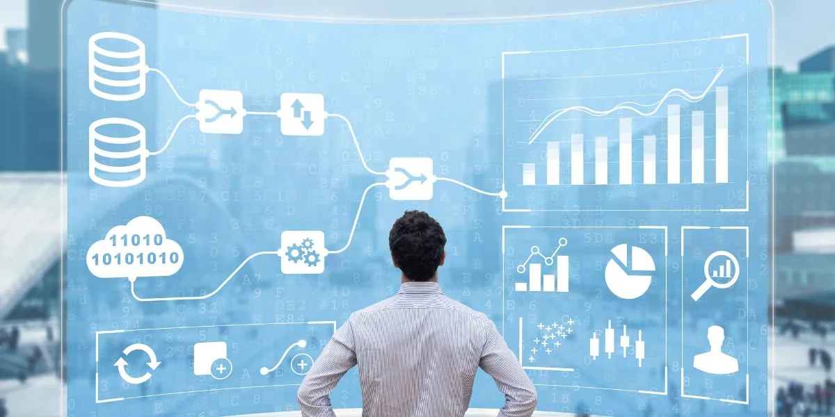 Professional man stands in front of a large wall covered in light blue and white marketing metrics and graphics