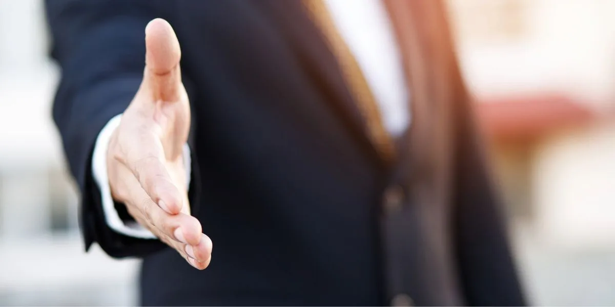 Close up of a business man holding out his hand to shake