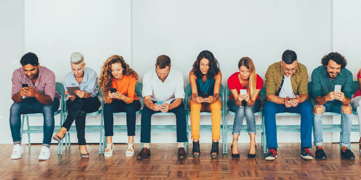 Group of people on their phones scrolling social media