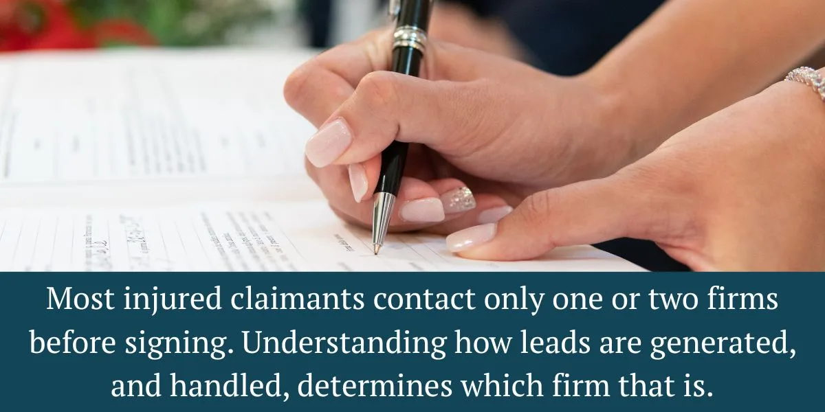 Personal injury attorney reviewing new auto accident lead inquiries at a law office desk 