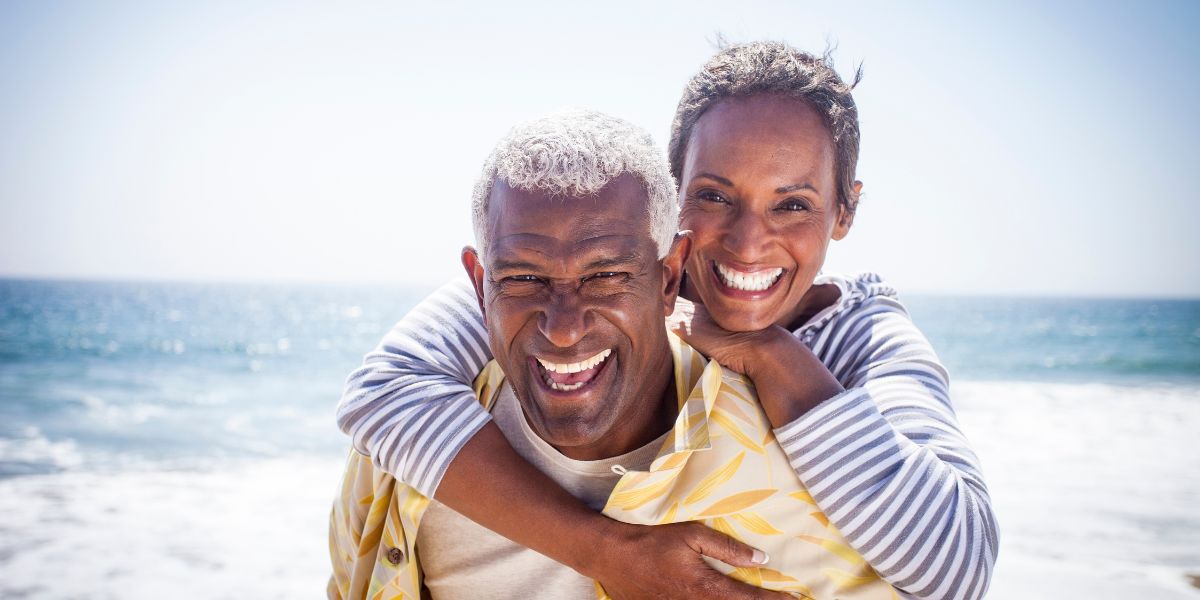 Happy Black couple enjoying the beach